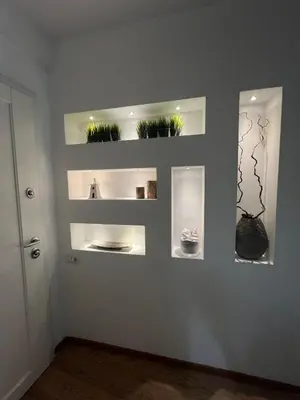a room with shelves on the wall with plants at La casa di Rosina al Pigneto in Rome