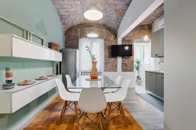 a kitchen with a glass table and white chairs at Clemente XII Repubblica House - 3 Bedroom Apartment in Rome