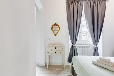a bedroom with a bed and a window at Clemente XII Repubblica House - 3 Bedroom Apartment in Rome