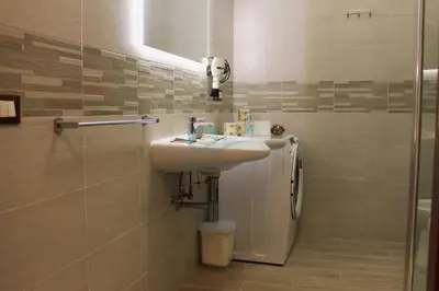 a bathroom with a sink and a shower at Mary's Suite Aventino in Rome