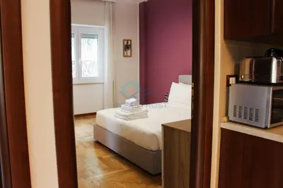 a small room with a bed and a microwave at Mary's Suite Aventino in Rome