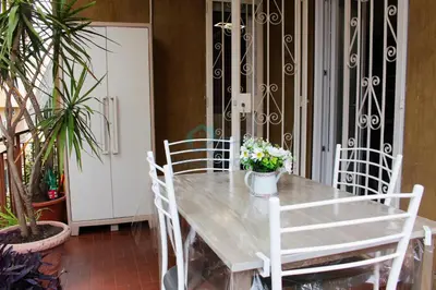 a dining room table with white chairs and plants at Mary's Suite Aventino in Rome