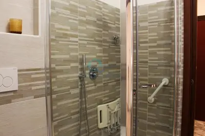 a shower with a glass door in a bathroom at Mary's Suite Aventino in Rome