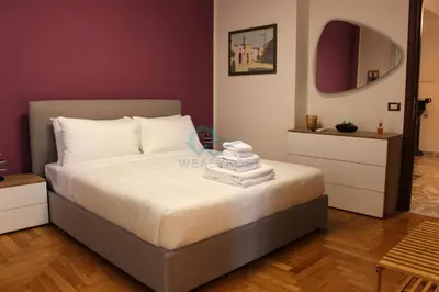 a bedroom with a bed with towels on it at Mary's Suite Aventino in Rome