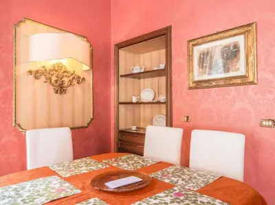 a dining room with a table and a mirror at Luxury Apartment Spanish Steps in Rome