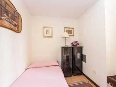 a white room with a bed and a table at Luxury Apartment Spanish Steps in Rome