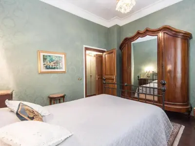 a bedroom with a bed and a large mirror at Luxury Apartment Spanish Steps in Rome