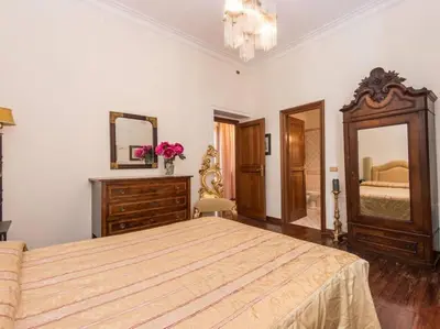 a bedroom with a bed and a dresser and a mirror at Luxury Apartment Spanish Steps in Rome