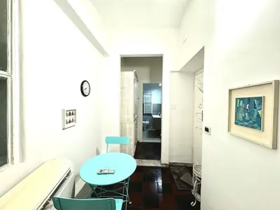 a hallway with a table and chairs in a room at Maison Borghetto - Vatican Flat in Rome