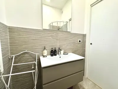 a bathroom with a sink and a mirror at Maison Borghetto - Vatican Flat in Rome