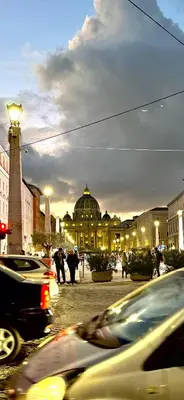 a city street with cars parked in front of a building at Maison Borghetto - Vatican Flat in Rome