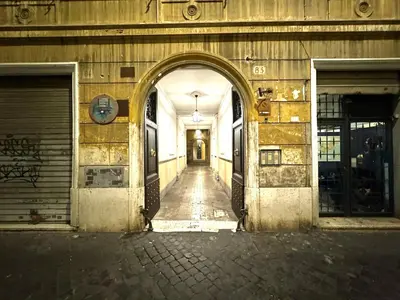an empty hallway of a building with an archway at Maison Borghetto - Vatican Flat in Rome