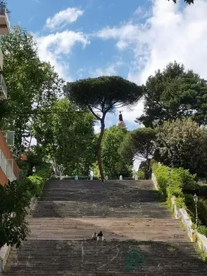 a group of people sitting on the stairs in a park at Perfect Hideout in Trastevere in Rome