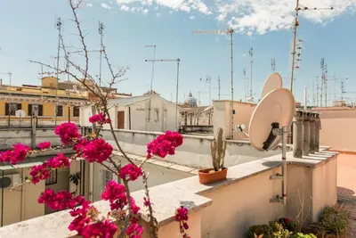 a view from the roof of a building with pink flowers at Vatican Dolce Vita in Rome