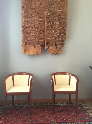 two wooden chairs sitting next to a wall at Vatican Dolce Vita in Rome