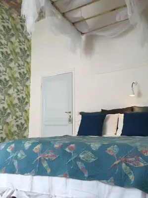 a bedroom with a bed with a blue comforter at Vatican Dolce Vita in Rome
