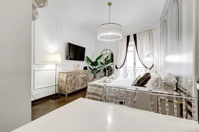 a white room with a bed and a tv at NEXT TO SPANISH SQUARE - RomeDreamHome in Rome