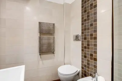 a white bathroom with a toilet and a sink at NEXT TO SPANISH SQUARE - RomeDreamHome in Rome