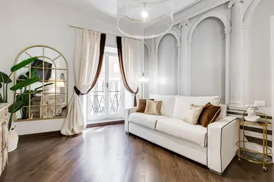 a living room with a white couch and a window at NEXT TO SPANISH SQUARE - RomeDreamHome in Rome