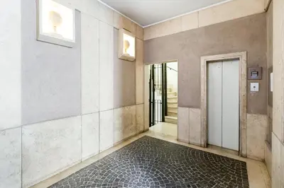 an empty hallway with a door and a tile floor at NEXT TO SPANISH SQUARE - RomeDreamHome in Rome