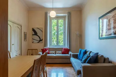 a living room with a couch and a table at JOIVY Window on the Tevere in Rome