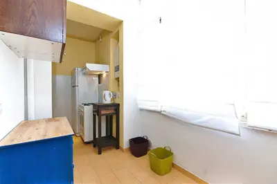 a kitchen with a refrigerator and a table in it at Rome Sleep Home Bed & Breakfast in Rome