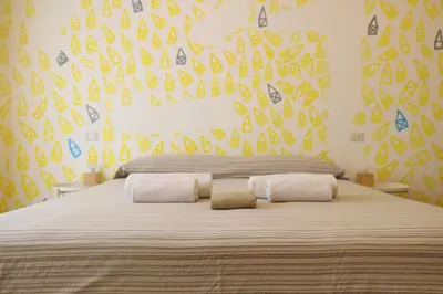 a bedroom with a large bed with a yellow wall at Rome Sleep Home Bed & Breakfast in Rome