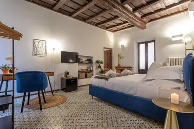 a bedroom with a bed and a table and a desk at 18 Ciancaleoni House in Rome