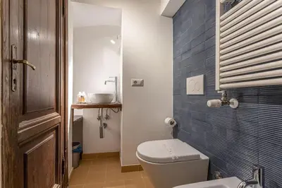 a bathroom with a toilet and a sink at 18 Ciancaleoni House in Rome