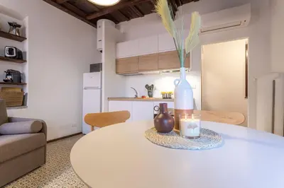 a white table with a vase on it in a kitchen at 18 Ciancaleoni House in Rome