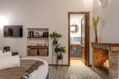 a bedroom with a bed and a fireplace at 18 Ciancaleoni House in Rome