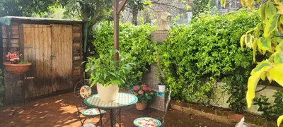 a patio with a table and plants and a fence at Aventino Flat in Rome