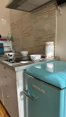 a kitchen with a blue refrigerator and a counter at Aventino Flat in Rome