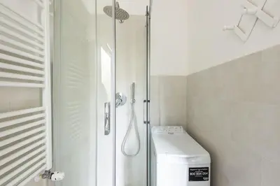 a bathroom with a shower and a toilet in it at Vatican Cosy Apartment in Rome