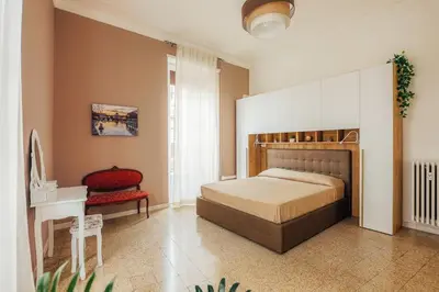 a bedroom with a bed and a chair and a desk at Grazioli Vatican Home in Rome