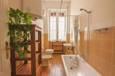 a bathroom with a tub and a toilet and a sink at Grazioli Vatican Home in Rome