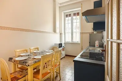 a kitchen with a table with chairs and a stove at Grazioli Vatican Home in Rome