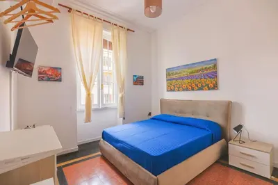 a bedroom with a bed and a desk in it at Grazioli Vatican Home in Rome