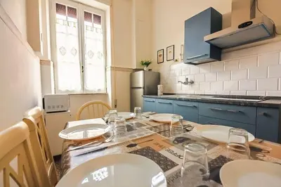a kitchen with a table with plates on it at Grazioli Vatican Home in Rome