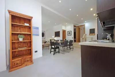 a kitchen and dining room with a table and chairs at Monte del Gallo Apartment for groups in Rome
