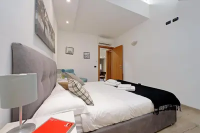 a bedroom with a bed and a desk with a lamp at Monte del Gallo Apartment for groups in Rome