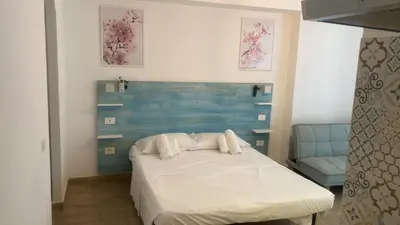 a bedroom with a bed and a blue headboard at Domus Turno by Local Domus in Rome