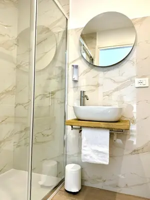 a bathroom with a sink and a mirror at Domus Turno by Local Domus in Rome