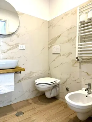a bathroom with a toilet and a sink at Domus Turno by Local Domus in Rome