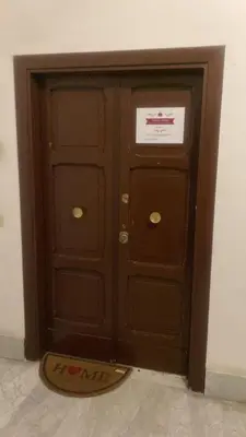 a wooden door with a sign on top of it at Domus Turno by Local Domus in Rome