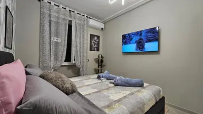 a bedroom with a bed with a tv on the wall at AquariHome 6 Apartment in Rome