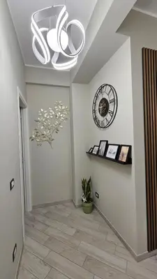 a hallway with a chandelier and a clock on the wall at AquariHome 6 Apartment in Rome
