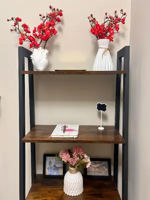 a shelf with two vases and flowers on it at AquariHome 6 Apartment in Rome