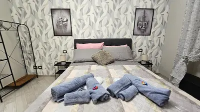 a bedroom with a bed with blue towels on it at AquariHome 6 Apartment in Rome