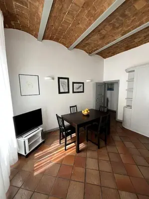 a dining room with a table and a television at TrastevereMoroni Gem in Rome
